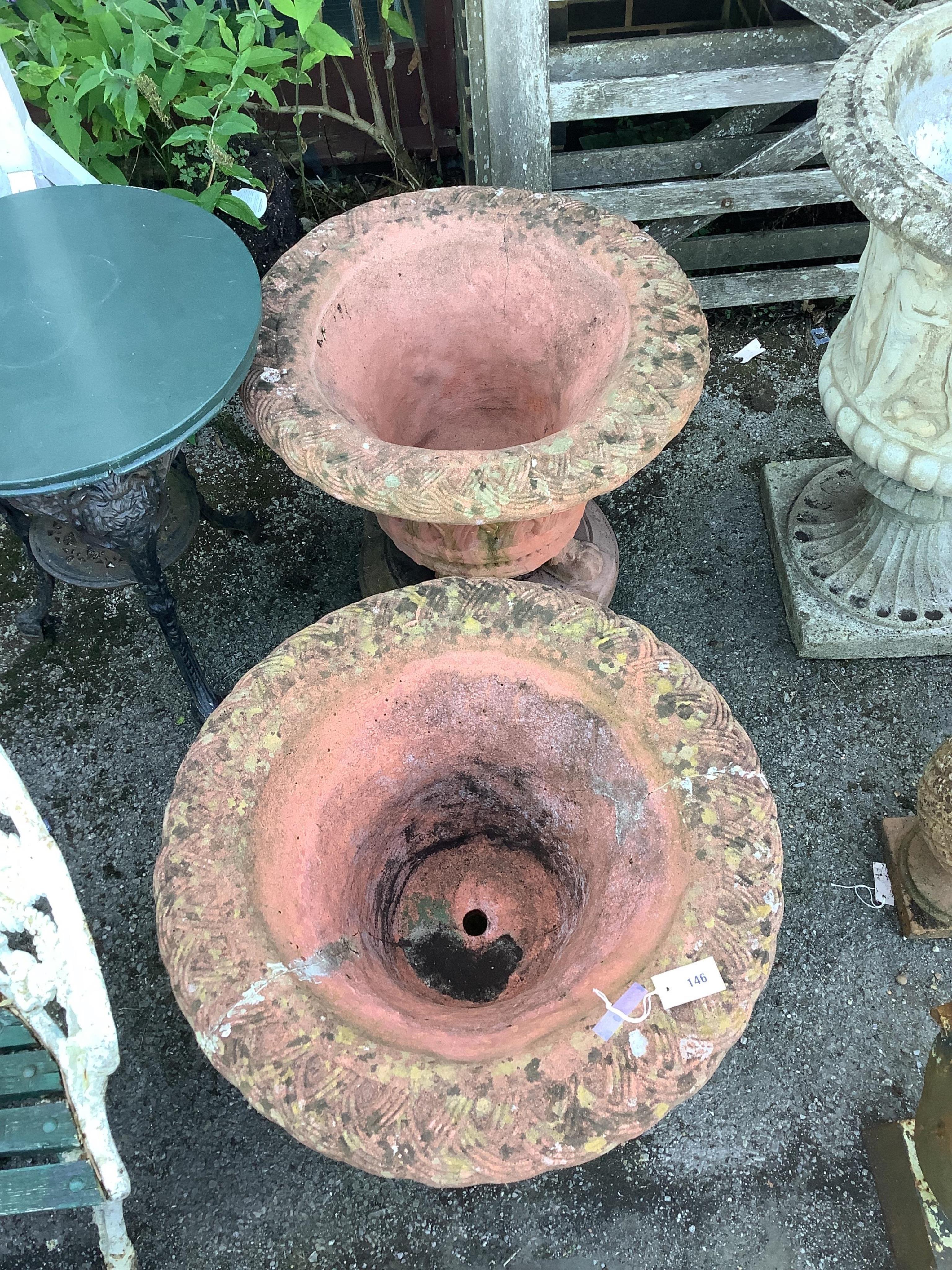 A pair of circular terracotta garden urns with basket weave bodies on lion's paw feet, diameter 72cm, height 60cm. Condition - poor to fair